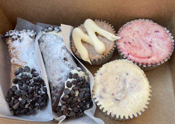 Original and chocolate-dipped "cannolis," cinnamon roll, raspberry swirl, and blueberry swirl cheesecake bites