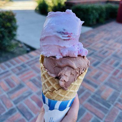 Two scoops of ice cream in a waffle cone