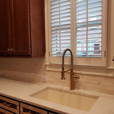 Quartz countertops and Marble backsplash