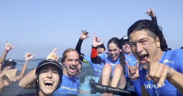 Stanbridge students volunteer at an adaptive surfing camp with Life Rolls On.