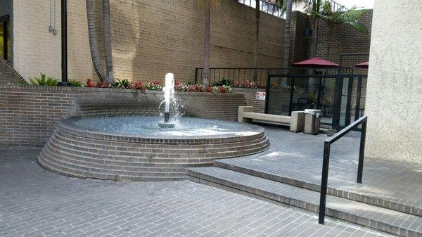 Little area on west side of front of building to sit and enjoy the fountain