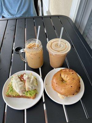 Loaded Avocado Toast on gluten free bread, Breakfast Sandwich on a French Toast Bagel, and two Home Sweet Home Lattes