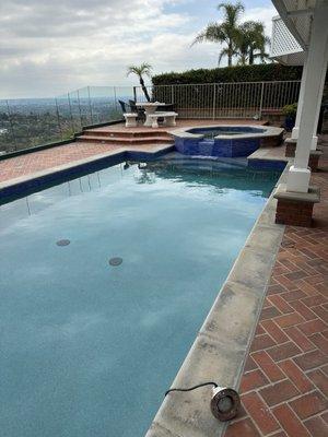 Updated glass tile around pool, and new pebble tec surface.