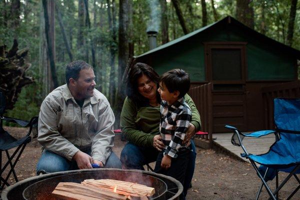 Each tent cabin has a fire ring and picnic table outside.