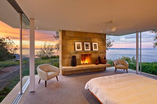 A clean bedroom with a fireplace!