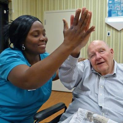 CNA and patient with high five!