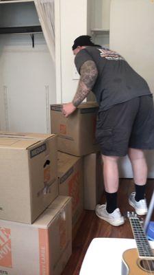 Dan from boss movers carefully taking the boxes out of my old bedroom