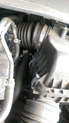 Check emission system light is on. Reason is because the intake tube has a big crack/whole. see pics.