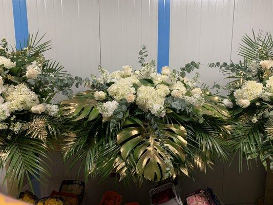 Uniquely arranged Casket Spray with Monstera Leaves and Hydrangeas