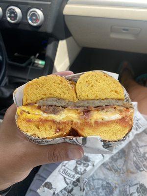 Everything egg bagel with sausage baca on egg and cheese. With salt, pepper, ketchup.