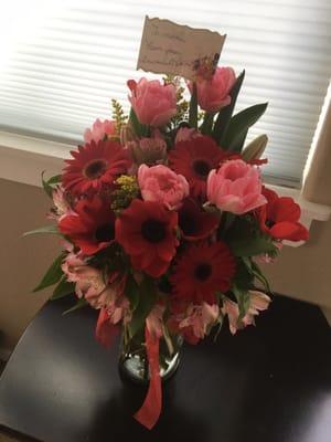 A "Get Well" themed bouquet with "lilies, no carnations, and whatever looks fresh and pretty"