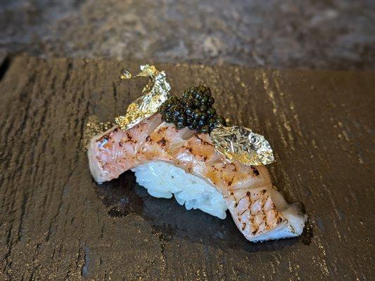 Salmon with gold leaf and caviar