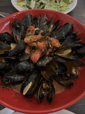 Mussels in white wine, lots of garlic and spicy tomato sauce. Ask for a lot of bread for dipping in the delicious sauce.