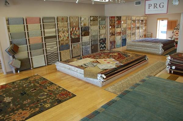 Our main showroom. Rugs are organized by size and style.  Or browse our selection of samples in our rug wall displays.