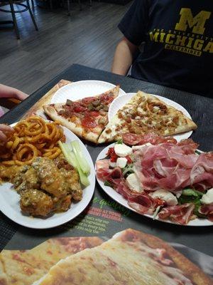 Italian Antipasto Salad, garlic Parm wings with curly fries, two slices specialty pizza