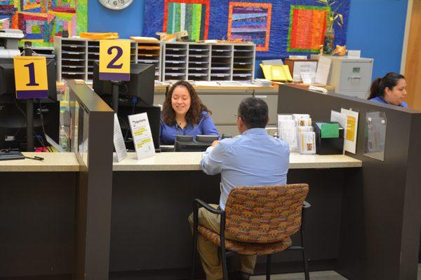 A receptionist welcomes a patient to the location