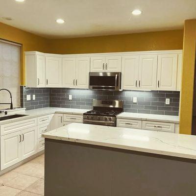 Prefabricated kitchen cabinets with quartz countertops and subway tile backsplash