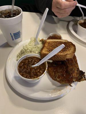 Barbecue chicken, coleslaw, baked beans, Texas toast, and a drink.