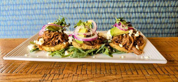 Fried green tomato start topped with house made pulled pork, red onion, feta cheese.