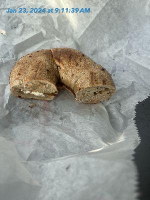 A bagel with cream cheese. But there's barely any cream cheese on it.