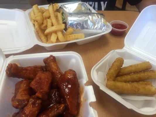 Hot bbq wings, mozzarella sticks, fries, and cheesesteak