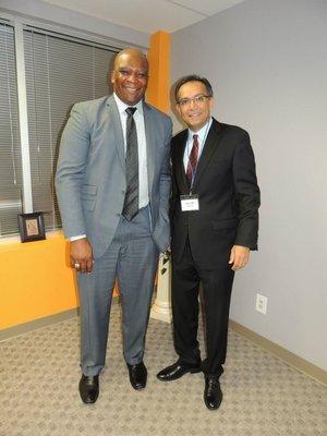 Salim with NFL Football player, Howard Cross, at office opening in Morganville, NJ.