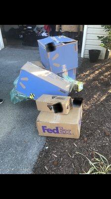 Packages thrown into the mulch by the garage door