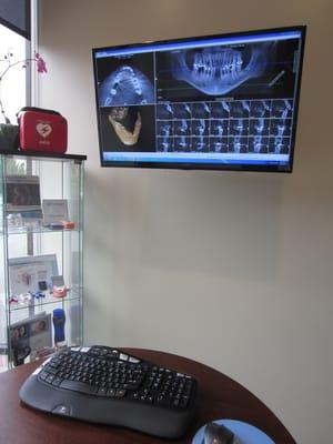 Consultation room where patients can see and feel dental implants, porcelain crowns and the latest dental technologies.