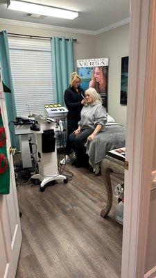 Dr.Angela Fogel treating her # 1 patient- her mothers shoulder with shock wave therapy.