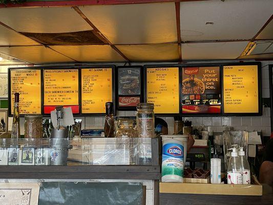 Menu board as of my 10/16/24 visit. Ceiling tiles in disrepair and overall, a little messy.