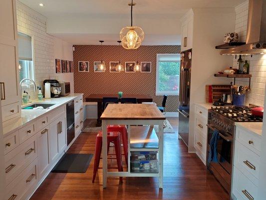 Bold fixtures and finishes pop with the painted white shaker cabinets, perfectly complementing this Ballard craftsman.