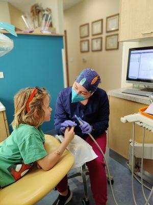 Dental Assistant Stephanie helping patient feel comfortable with dental tools.