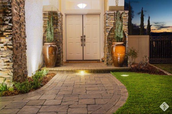 Entryway makeover featuring paver installation, ambient outdoor lighting and accent planters