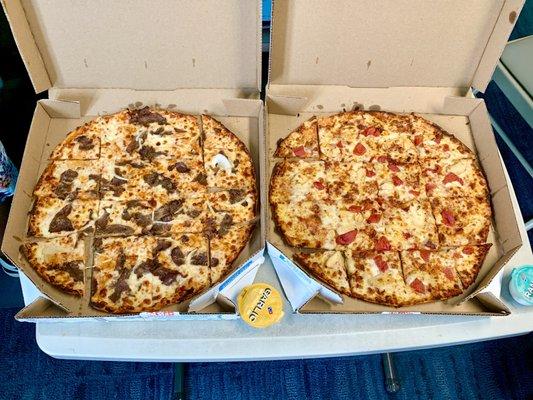 Left pie is a Philly cheesesteak Pizza and the one on the right a two topping sausage and pepperoni both on thin crust.