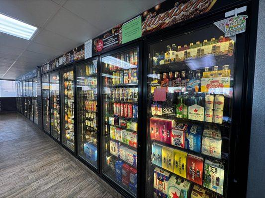 Coolers stocked with an array of beer, seltzers, and beverages.