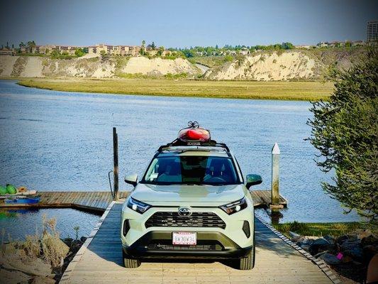 Our new RAV4, dockside at the Newport Aquatic Center with our BARK Prone Paddleboard on top.