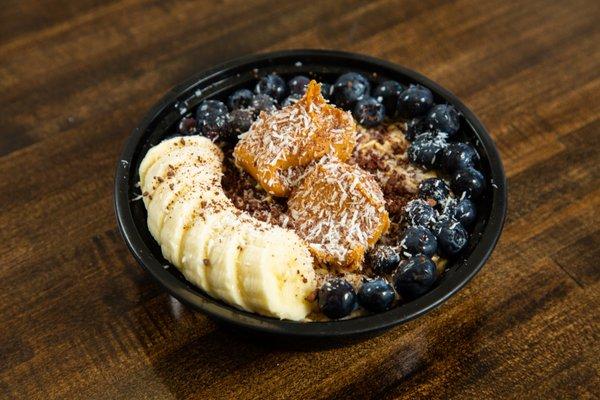 Oatmeal Bowl: Oatmeal Base, Peanut Butter Coconut Shreds Shaved Callebaut Chocolate, Banana, Blueberries, Agave