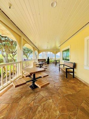 Wrap around porch with tables.