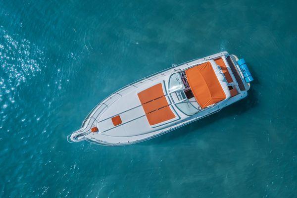 Experience outdoor elegance with vibrant orange seating on our yacht. Revel in comfort and style as you enjoy the sea breeze.