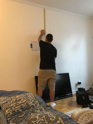 TV mounting in progress. Measuring for the best results!