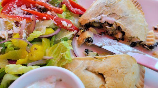 Mediterranean empanada with tzatziki sauce and Greek salad.