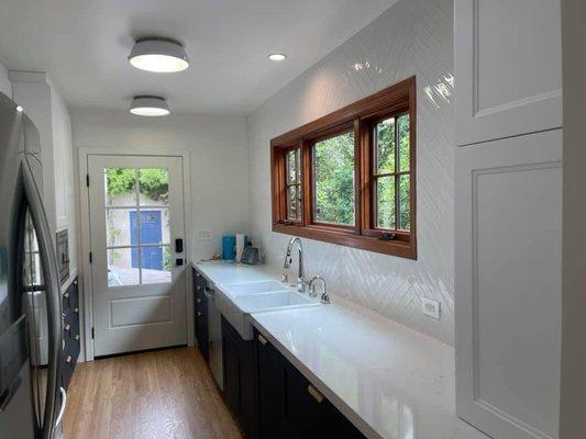 Kitchen with custom stained windows.