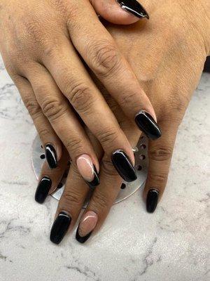 Black gel manicure with accented French tip ring finger