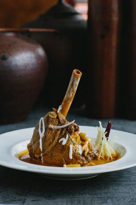 Slow-braised lamb shank simmered in northern Thai red curry, peanuts, potatoes and ginger