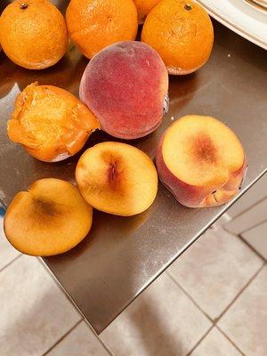 Rotting Clementines and peaches.