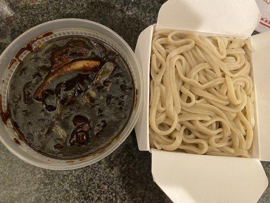 Jja jjang myun (black bean noodles) with seafood and beef