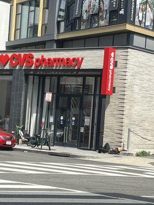 Someone is sleeping DIRECTLY outside of the CVS.