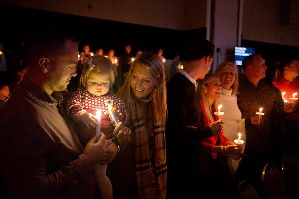 Three generations enjoying Salem's Christmas Eve Candlelight Service together