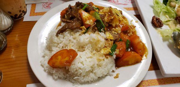 Beef with tomato over rice