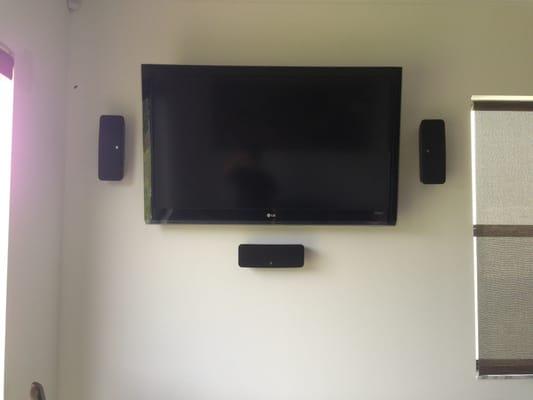 Lg 55" with wall mounted speakers.  No wires showing! Very clean